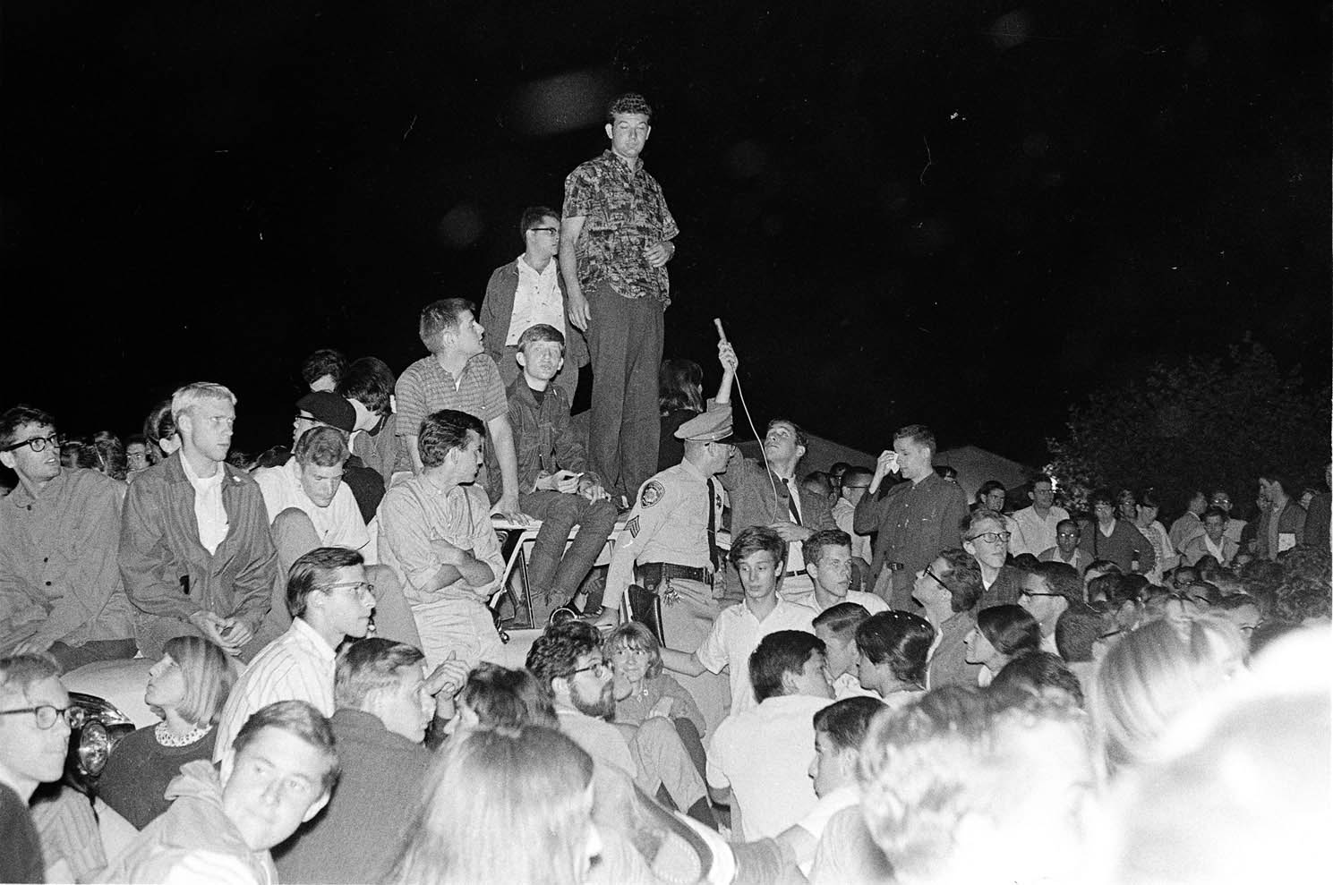 Steven Marcus, Art Goldberg and other students surrounding and on top of the police car during night of 10-1-1964